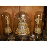 A magnificent French clock garniture under glass domes. The clock surmounted a horse with handler,