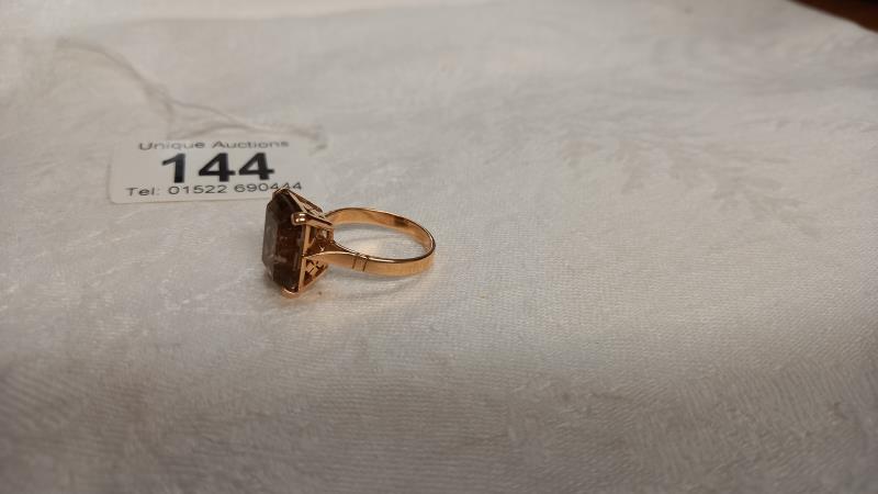 A gold ring set with smoky quartz in openwork mount, size O, 5.7 grams. - Image 2 of 2