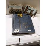 A post card album and loose bundles of post cards.