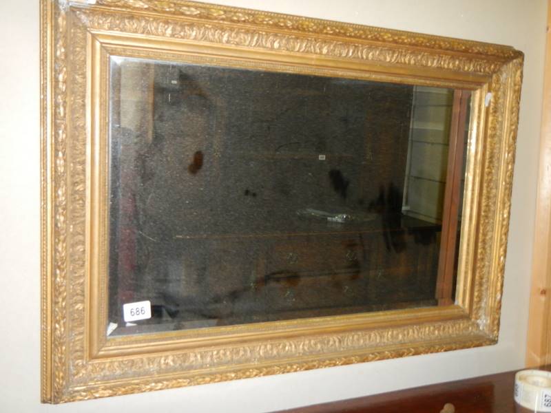 An early 20th century gilt framed bevel edged mirror.