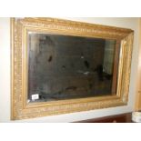 An early 20th century gilt framed bevel edged mirror.