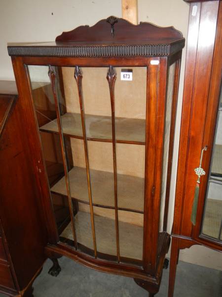 A mahogany single door display cabinet.