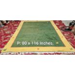 A green and yellow rug - 80 inches x 116 inches (COLLECT ONLY)