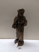 A carved wood figure of a boy, (30 cent hiwat).