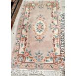 A beige patterned rug - 130 inches x 126 inches (COLLECT ONLY)