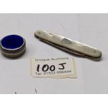 A silver and enamel pill box and a silver and mother of pearl pen knife.