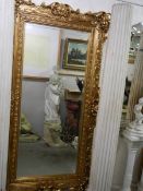 A rectangular mirror in ornate gilt frame, COLLECT ONLY.