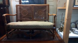 An Edwardian bergÃ¨re back 2 seat carver chair
