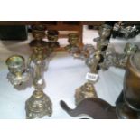 An ornate pr of brass candelabra