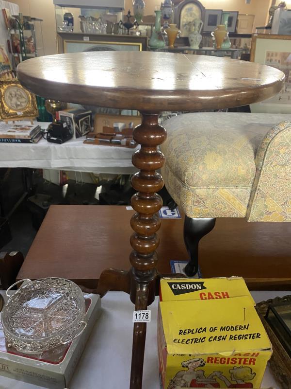 A Victorian mahogany tea table on bun turned column & tripod base