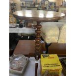 A Victorian mahogany tea table on bun turned column & tripod base