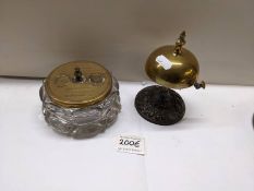 A brass shop bell and a glass inkwell with brass top.