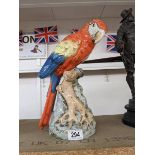 A Royal Dux figure of a macaw.