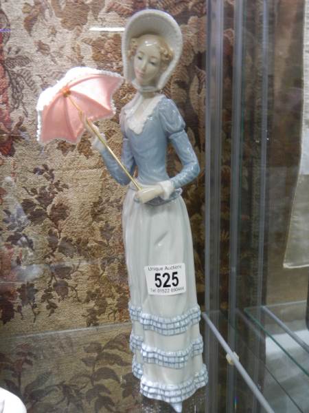 A Lladro figure of a lady with parasol.