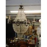 A fabulous brass 'basket' chandelier with over 4000 crystals. COLLECT ONLY.