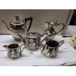 A three piece silver plate tea set, coffee pot and water jug.