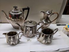 A three piece silver plate tea set, coffee pot and water jug.