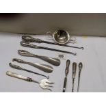 A mixed lot of shoe horns, button hooks etc., some with silver handles, and a plated tea strainer.
