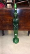 A tall green glass bottle in form of a knight in armour height 80cm Collect only