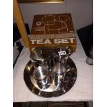 A 5 piece stainless steel tea set