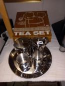 A 5 piece stainless steel tea set