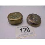 Two antique embossed metal pill boxes.