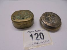 Two antique embossed metal pill boxes.