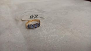 Four oval tanzanites interspaced with three rows of diamonds in 18ct gold ring, size P half, 3.7 g