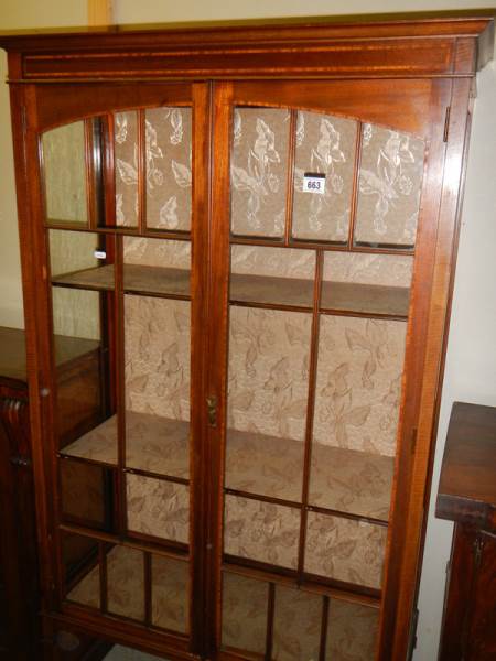 An Edwardian two door display cabinet.