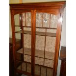 An Edwardian two door display cabinet.