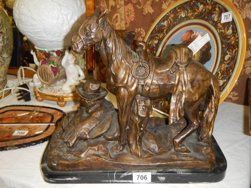 A heavy bronze figure of a horse with cowboy.