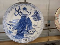 A chinese blue and white porcelaind plate with an empress figure, signed.