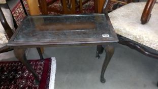 An Eastern carved top coffee table with glass insert - 66cm x 35cm x 49cm high COLLECT ONLY.