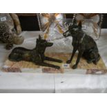 An art deco sculpture of two Alsation dogs on a marble base.