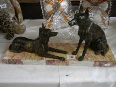 An art deco sculpture of two Alsation dogs on a marble base.