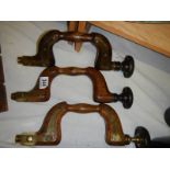 Three antique brass mounted braces.