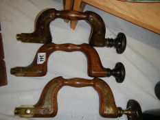 Three antique brass mounted braces.
