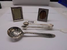 An EPNS sugar sifter spoon, sugar tongs and two miniature photo frames.
