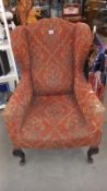 An Edwardian wing arm chair