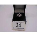 An 18ct white gold floral diamond ring, size O, 5.4 grams