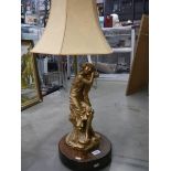 A spelter figural table lamp with shade.