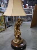 A spelter figural table lamp with shade.