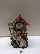 A bisque porcelain mantel clock featuring a boy and girl.