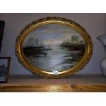 A gilt framed oval oil on board of a lone fisherman, signed A E Webster - 58cm x 48cm (COLLECT