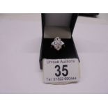 A five section floral white gold and diamond ring, size N half, 5.5 grams.