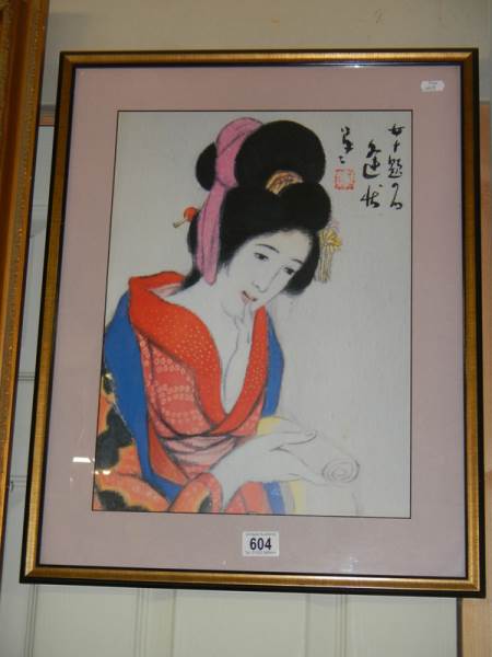 A 20th century Japanese print of a young lady holding a scroll, 48 x 61 cm.