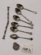 Six silver spoons, a silver badge and one other silver item 54.5 grams.