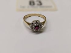 A ruby and diamond cluster ring, hall marked for London 1965, 18ct gold, size M, 3.1 grams.