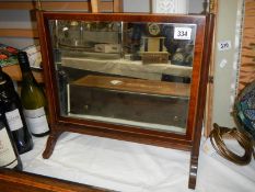 An Edwardian mahogany toilet mirror.