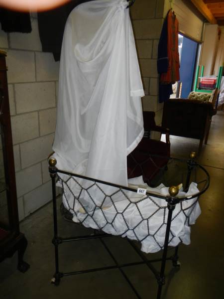 A late Victorian babies crib with drapes.
